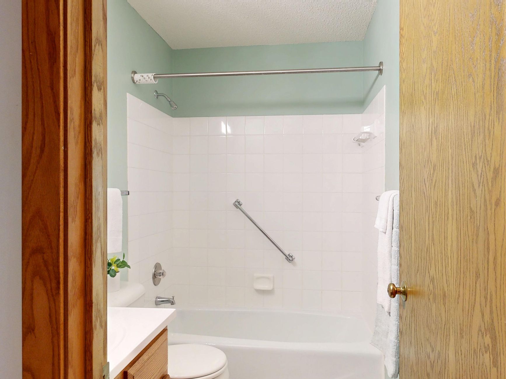 Clean, modern bathroom with tiled walls, relevant to home fall-prevention safety modifications