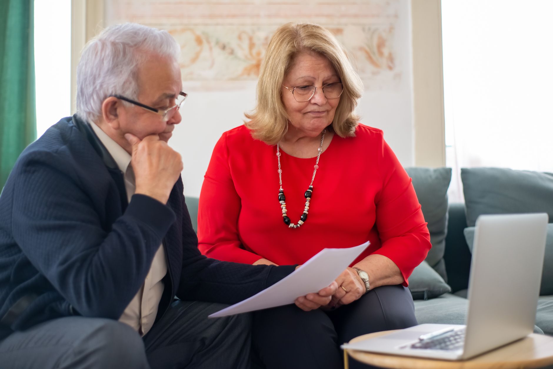 Elderly couple reviewing financial documents together, relevant to RMD calculator