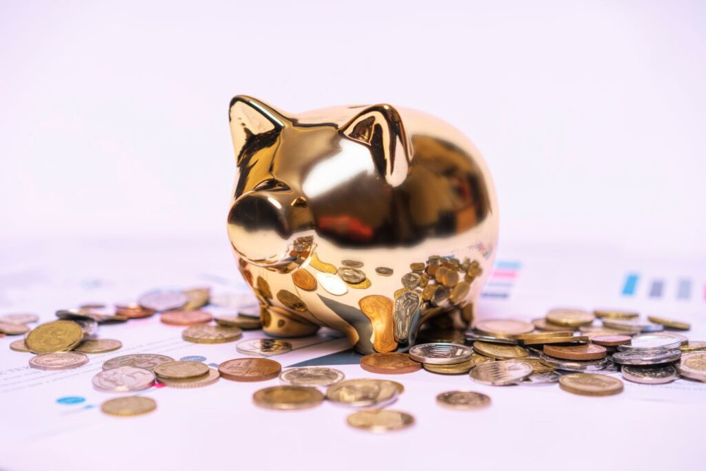 Golden piggy bank sitting on financial documents, representing a retirement savings nest egg