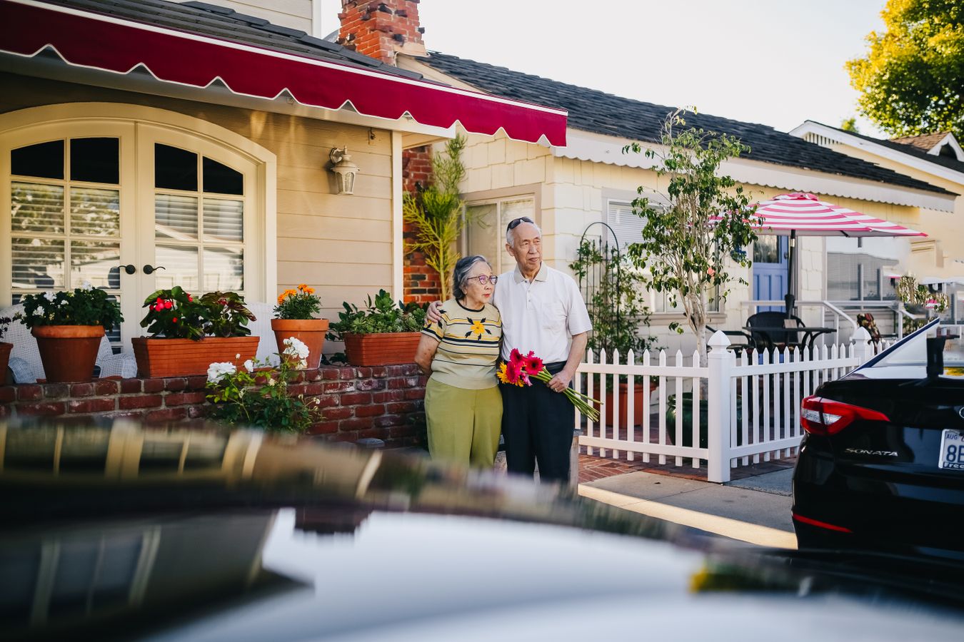 Retired couple outside their home, thinking about how reverse mortgages work