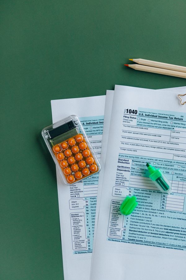 1040 tax forms with a calculator, used to figure out the tax cost of a Roth conversion